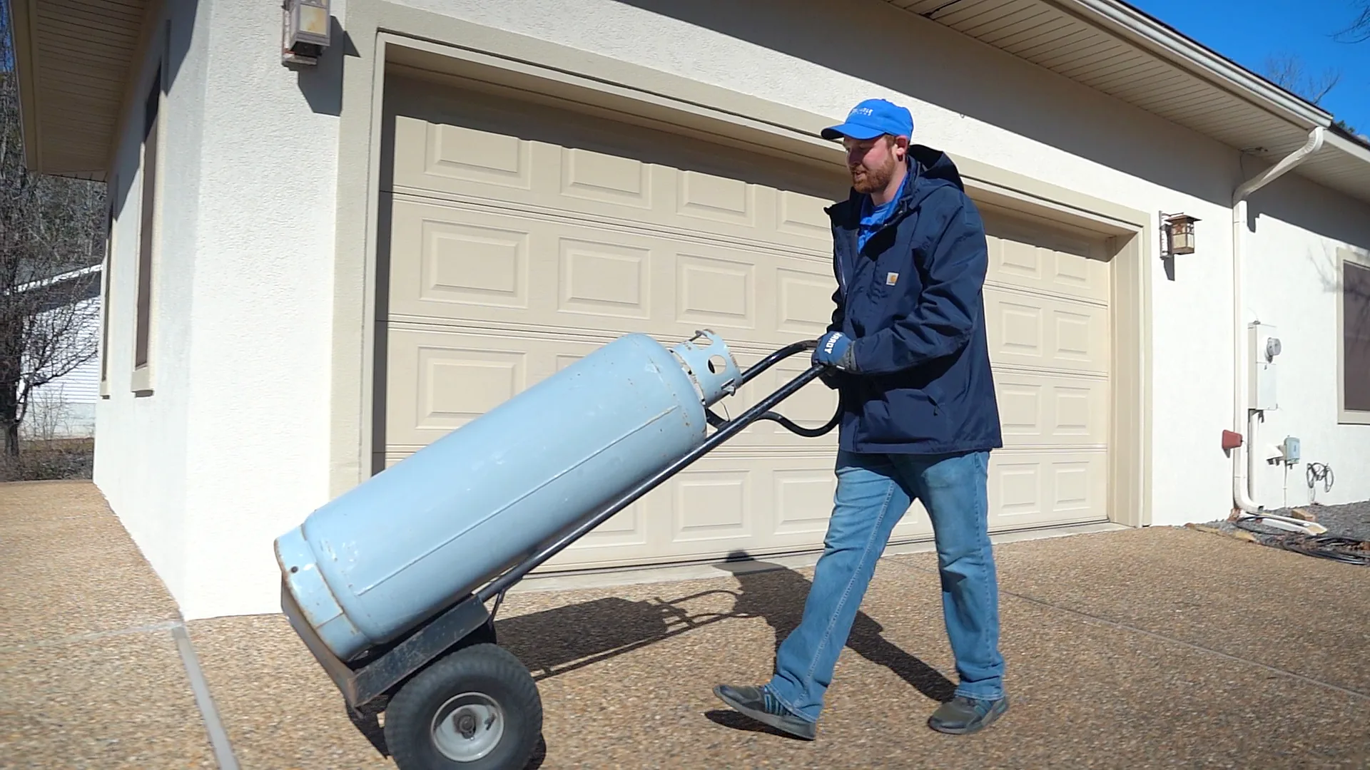 Reliable Propane driver delivering a propane cylinder to a Hot Springs Village home